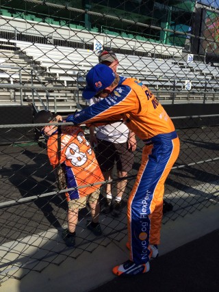 Meeting and signing for a young fan post-race.